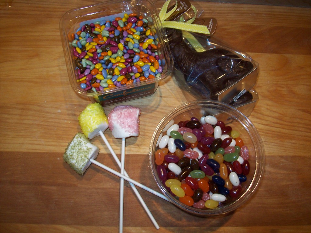 Dye-free Easter Sweets: Chocolate-covered sunflower seeds, dark chocolate bunnies, dye-free jelly beans, and organic marshmallows on lollipop sticks, moistened with water and rolled in dye-free sanding sugars