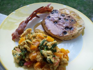 Blueberry pancakes, bacon, egg and vegetable scramble